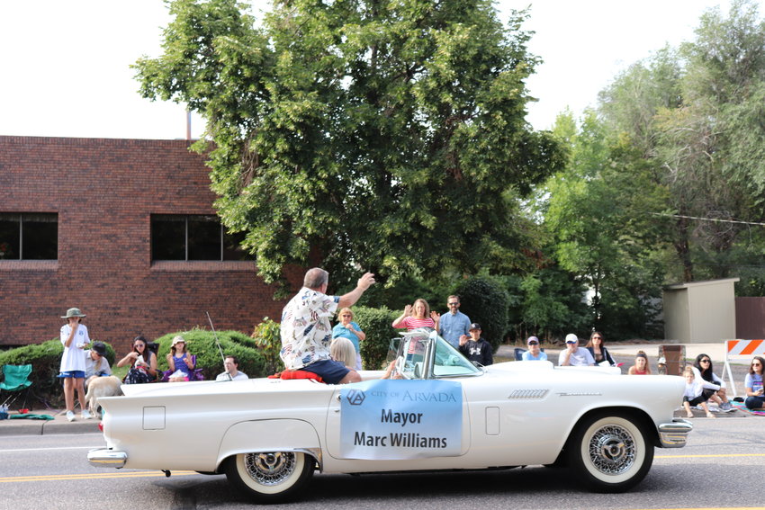 Mayor Marc Williams waves to locals lined up for the parade.